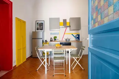 a kitchen with a table and a refrigerator at Elegant Two-Room Apartment with Balcony & Suite in Palermo