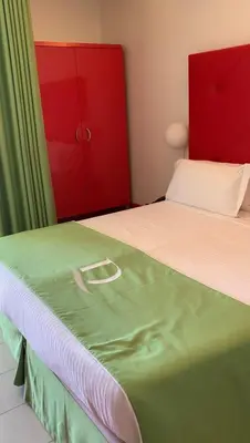 a bedroom with two beds and a red cabinet at Domina Zagarella multiproprietà MINIMO 6 NOTTI in Santa Flavia