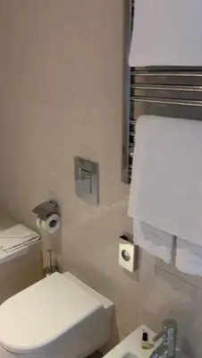 a bathroom with a white toilet and a sink at Domina Zagarella multiproprietà MINIMO 6 NOTTI in Santa Flavia