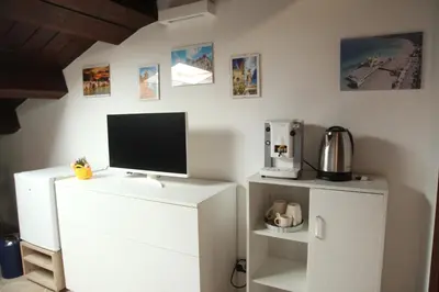 a white cabinet with a monitor on top of it at Centro storico apartment & Loft - Amnesia Holiday Home in Palermo