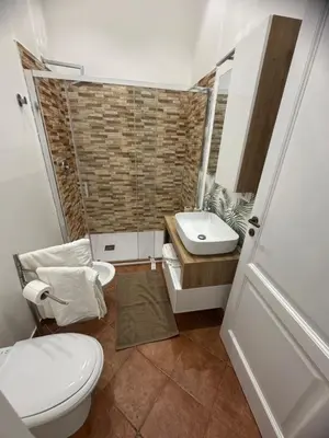 a bathroom with a toilet and a sink at Dimora Solemar-Mareluna village in Campofelice di Roccella