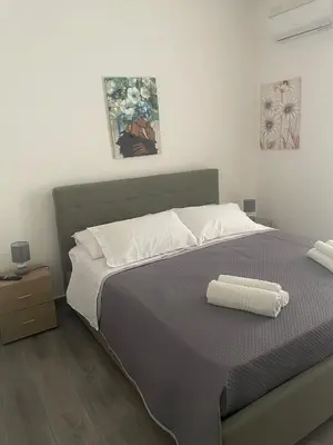 a bedroom with a bed with a towel on it at Altri tempi in Palermo