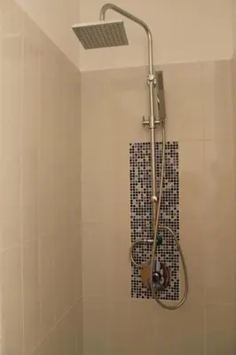 a shower with a shower head in a bathroom at Mondello Suites FLH - Riflessi in Palermo