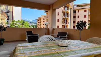 a table and chairs on a balcony with a view at Albachiara Apartment vicino al mare di Capaci in Capaci