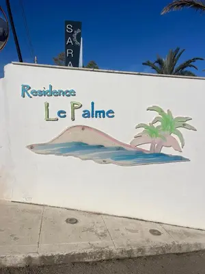 a sign for a restaurant with a fish on it at Le Palme House in Isola delle Femmine