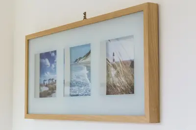 a picture frame with four pictures on a wall at Mondello suites FLH - Posidonia in Palermo
