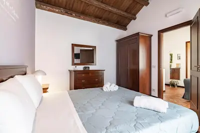 a bedroom with a large white bed with two towels on it at GuestHost - MiraVigghia Apartment in Palermo