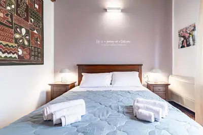 a bedroom with a bed with two towels on it at GuestHost - MiraVigghia Apartment in Palermo