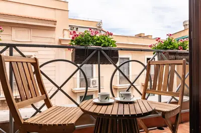 two chairs and a table on a balcony with two cups at GuestHost - MiraVigghia Apartment in Palermo