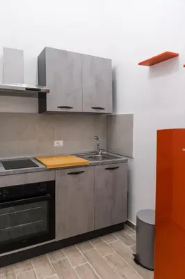 a kitchen with a sink and a stove at Serenello Home in Palermo