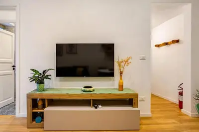 a living room with a tv and a table at Casa Vacanza Dante 17 Carini in Carini