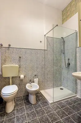 a bathroom with a toilet and a shower and a sink at Casa Vacanza Dante 17 Carini in Carini