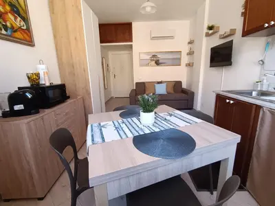 a kitchen with a table and chairs in a room at Mondello Sea House in Palermo