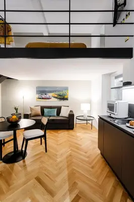 a living room with a couch and a table at Dimora Ai Leoni, Suite & Apartments in Palermo