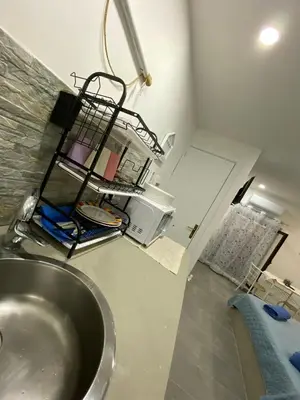 a kitchen with a sink and a microwave at Il sole siciliano in Palermo