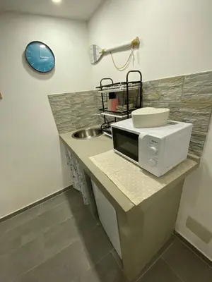 a microwave sitting on a counter next to a sink at Il sole siciliano in Palermo