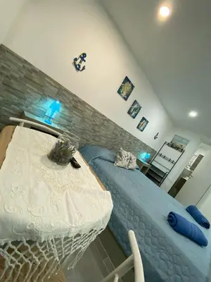 a bedroom with a bed and a table in it at Il sole siciliano in Palermo