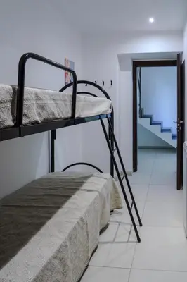 a room with two bunk beds and a staircase at CELSO E SAITTA per SAITTA HOLIDAYS in Palermo