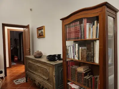 a bedroom with a bed and a painting on the wall at Villa Kinisia, antica dimora siciliana in Cinisi