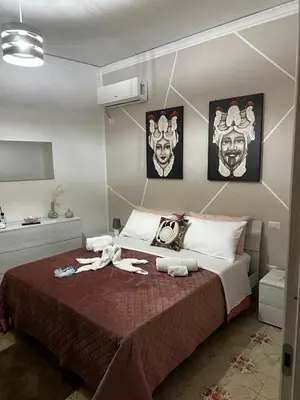 a bedroom with a bed with two people on it at Casa vacanze I mori in Bagheria