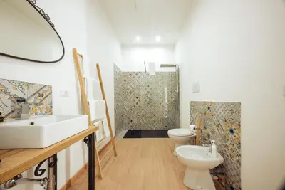 a bathroom with a sink and a toilet and a shower at Casa Ru Vecchio Re in Palermo