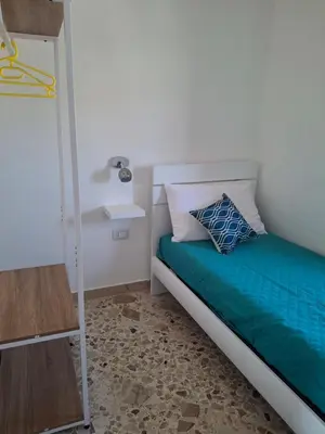 a small bedroom with a bed and a ladder at Mondello House29 in Palermo