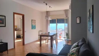 a living room with a couch and a dining room table at Il mare negli occhi in Porticello