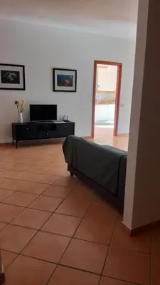 a living room with a couch and a television at Il mare negli occhi in Porticello
