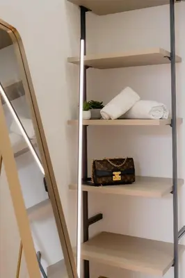 a closet with a ladder and a bag in it at Vincis Home in Palermo