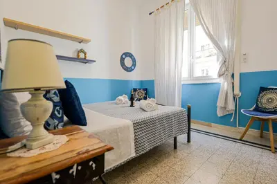 a bedroom with blue and white walls and a bed at House Via Napoli in Palermo