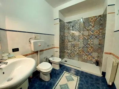 a bathroom with a sink and a toilet and a shower at House Via Napoli in Palermo