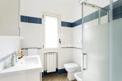 a bathroom with a toilet and a sink and a mirror at Cava in Scopello