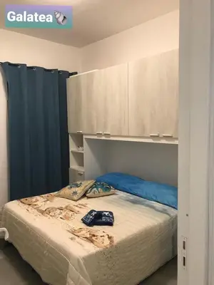 a bedroom with a bed with blue pillows on it at Casa vacanza galatea San vito lo capo in San Vito lo Capo