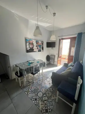a living room with a table and a couch at Casa vacanza galatea San vito lo capo in San Vito lo Capo