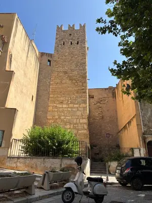 a scooter parked in front of a castle at Casa Vacanze Mazzini, amazing Rooftop! in Termini Imerese