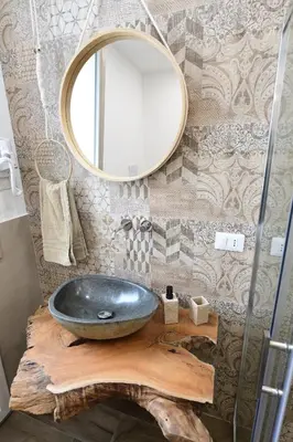 a bathroom with a black sink and a mirror at Ummi Taliari in Terrasini