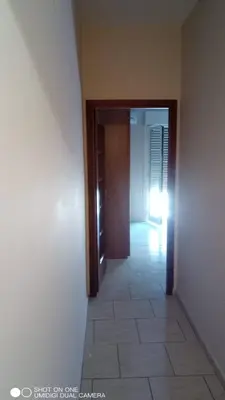 a hallway with a door and a tile floor at Nicitra in Isola delle Femmine