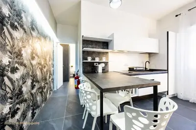 a kitchen and dining room with a table and chairs at Calatafimi House in Palermo