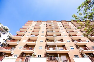 a tall apartment building with balconies on it at Calatafimi House in Palermo