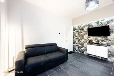a living room with a couch and a flat screen tv at Calatafimi House in Palermo