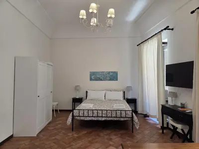 a bedroom with a bed and a chandelier at A Casa di Iside in Palermo