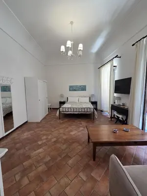 a living room with a bed and a coffee table at A Casa di Iside in Palermo