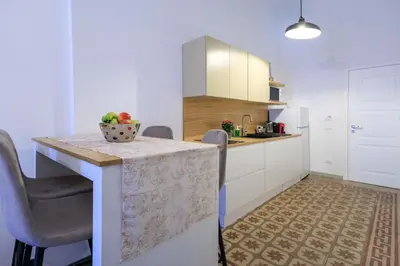 a kitchen with a table with a bowl of fruit on it at Suites Santa Cecilia in Palermo