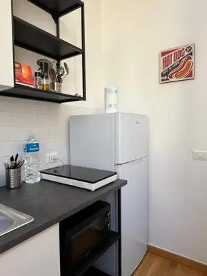 a kitchen with a white refrigerator and a sink at Matteo's House in Palermo