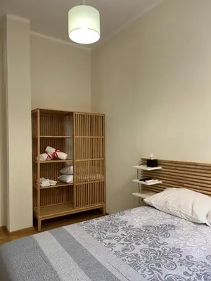 a bedroom with a bed and a shelf with shoes at Matteo's House in Palermo