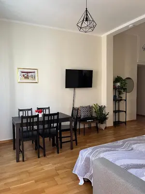 a dining room with a table and chairs and a tv at Matteo's House in Palermo