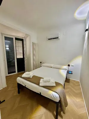 a bedroom with a bed with towels on it at Ai Limoni in Palermo