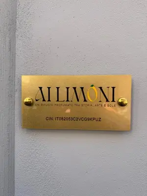 a sign on a wall that says aluminati at Ai Limoni in Palermo