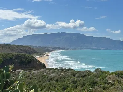 a view of a beach with mountains in the background at Casa Miramara Sicilia in Balestrate
