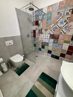 a bathroom with a shower and a toilet and a sink at Casa Miramara Sicilia in Balestrate